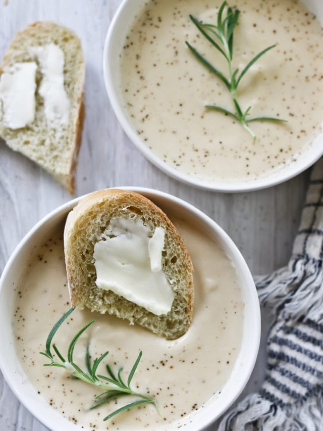 A warm bowl of creamy cauliflower soup and a slice of homemade brean