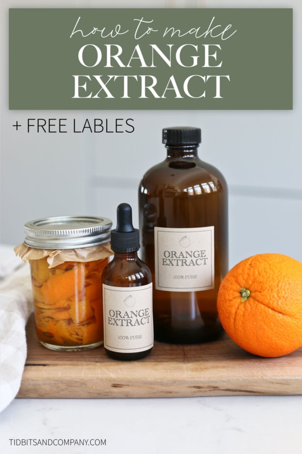 Glass bottles of orange extract sit next to an orange