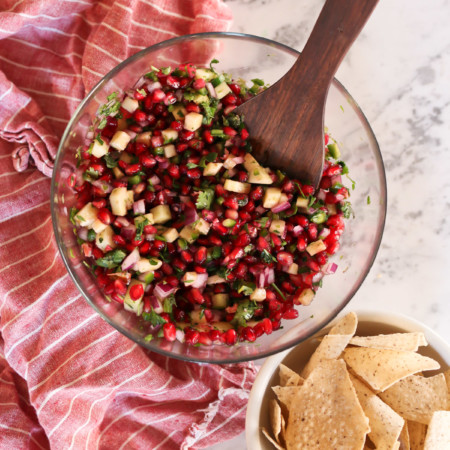 A bowl of fresh pomegranate salsa and tortilla chips