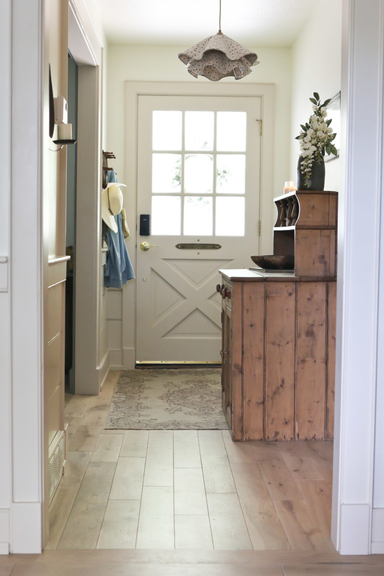 The view down a hallway to the front entrance of an English cottage home