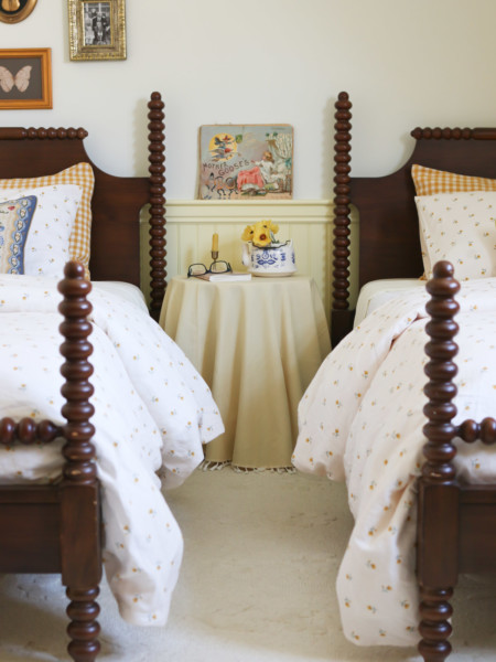 A set of matching twin sized beds with dark wood and spindle legs