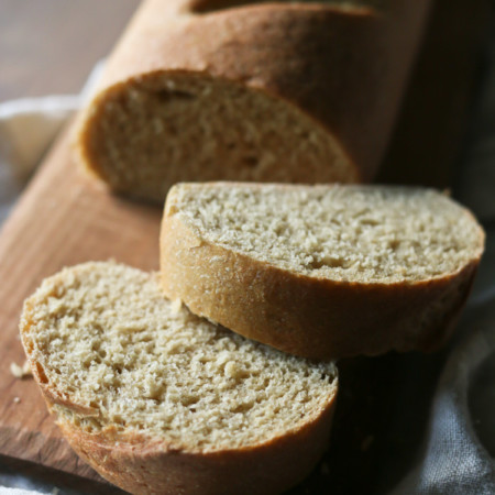 A sliced loaf of homemade French bread made with 100% whole grain freshly milled flour