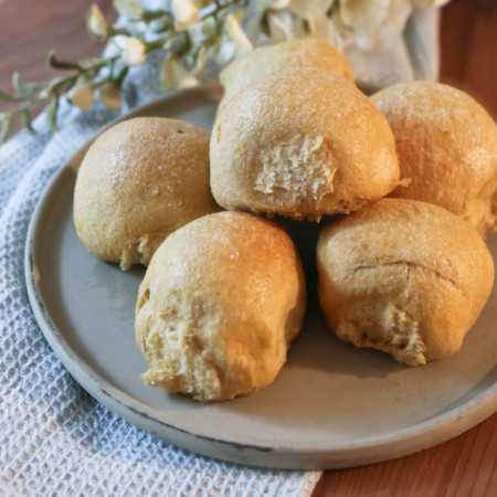 A platter holds several sweet Hawaiian dinner rolls that are homemade with fresh milled flour
