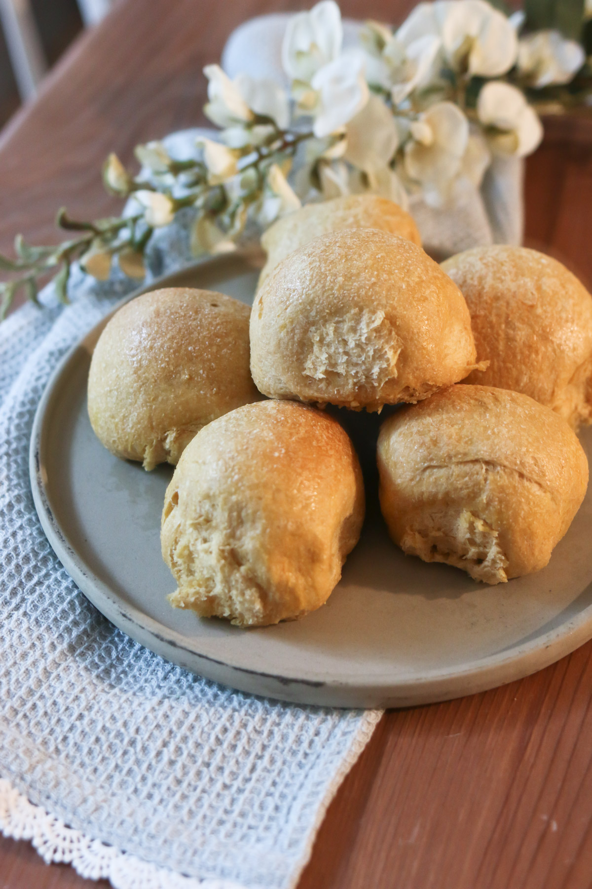 A platter holds several sweet Hawaiian dinner rolls that are homemade with a fresh milled flour recipe