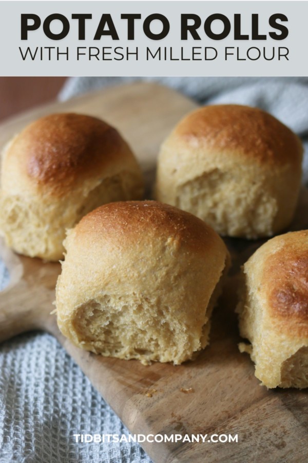 Several homemade rolls made with potato and freshly milled flour are displayed on a cutting board