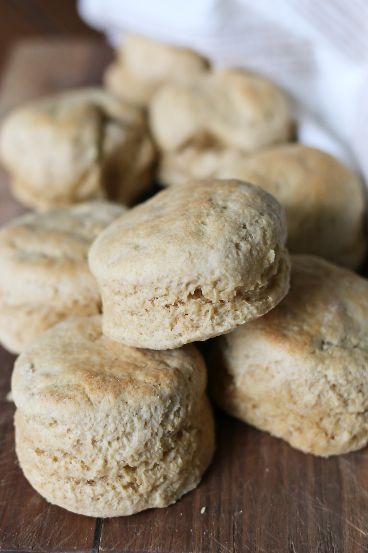 Biscuits made using freshly milled whole wheat flour are piled onto a cutting board