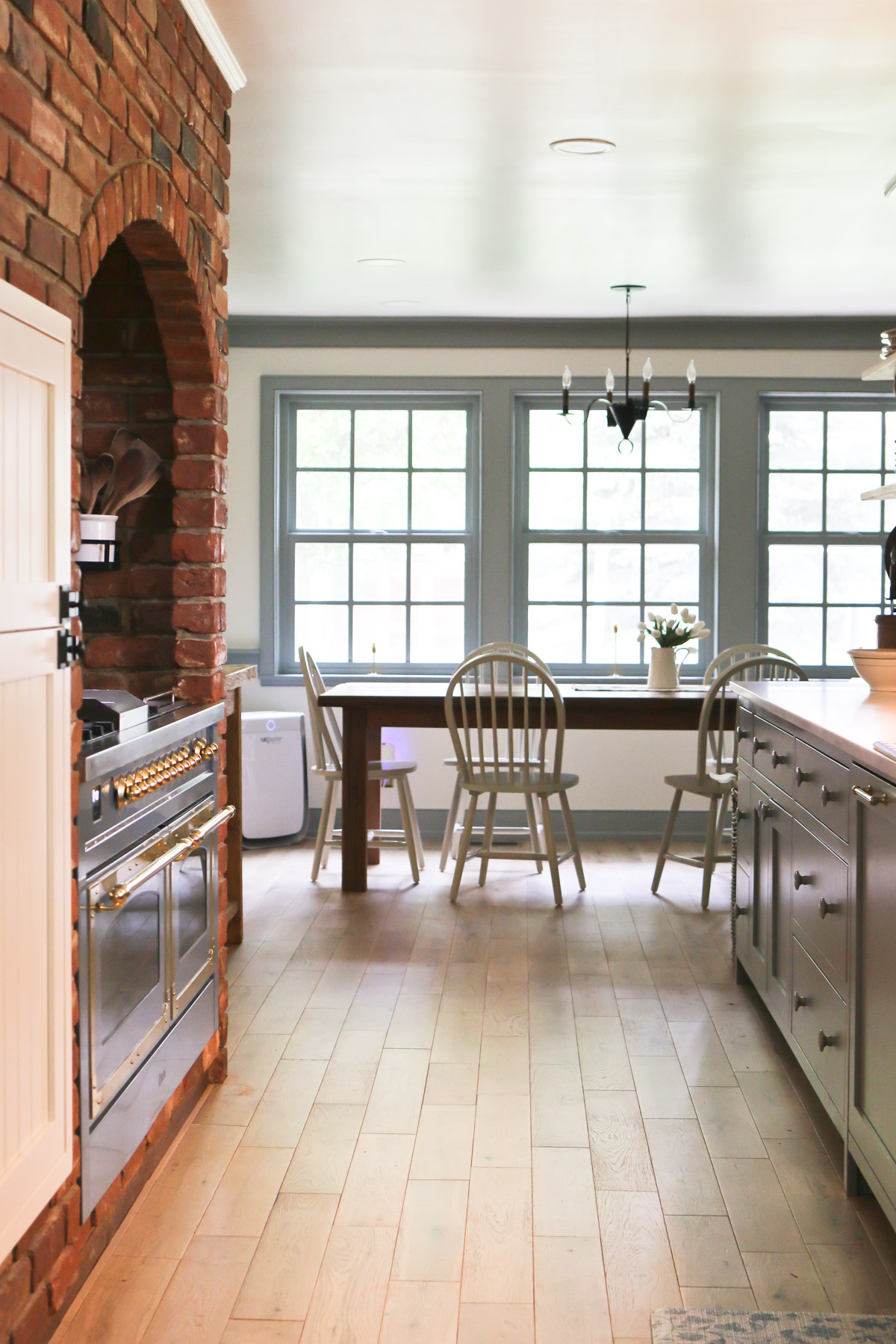 A view through the Lavender Blue kitchen into the dining area that is set with a table and chairs