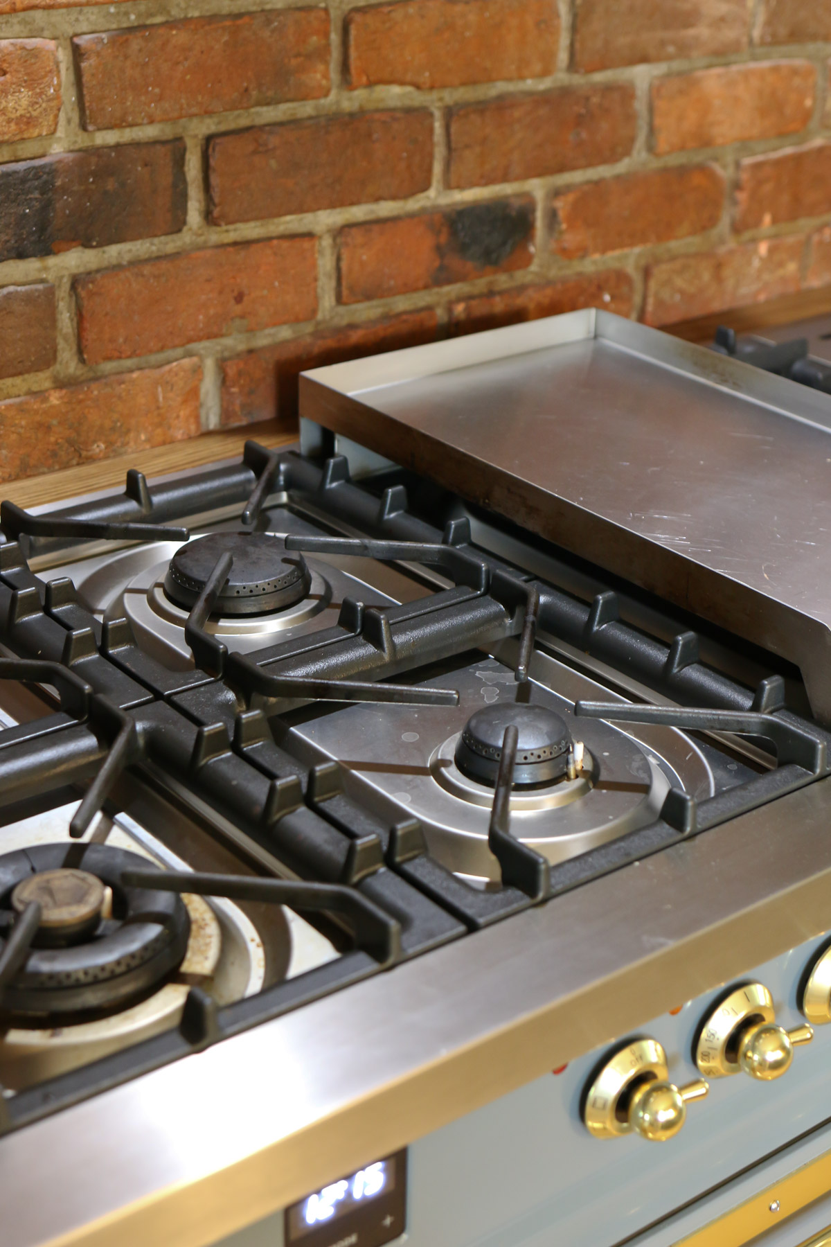 Several burner and a griddle top are shown on an ILVE Nostalgie range