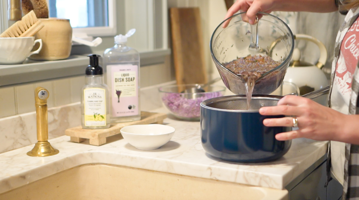 Lilac tea is strained prior to making it into lilac jelly