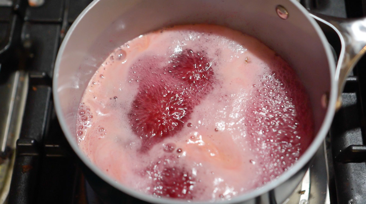 Pectin and lilac tea are boiling together to make lilac jelly