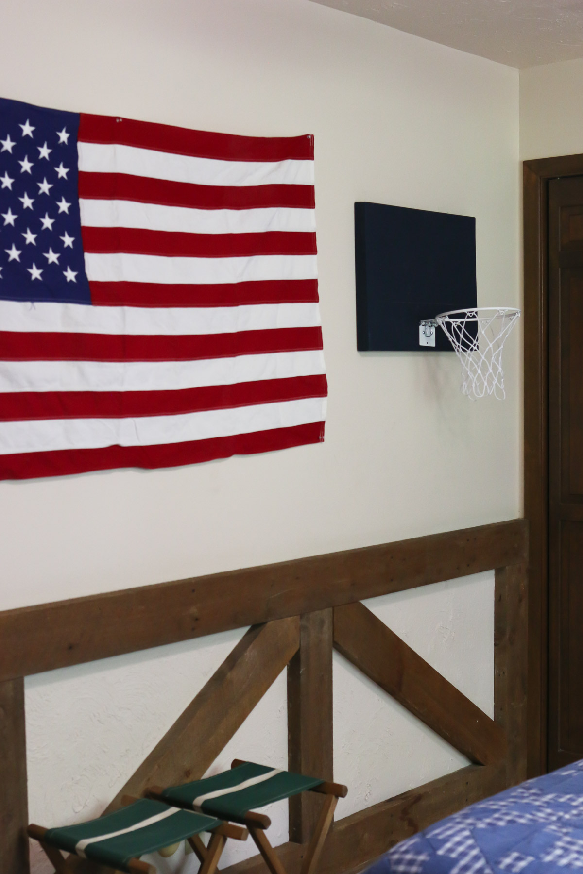 An American flag is hung up on a bedroom wall as a patriotic decoration