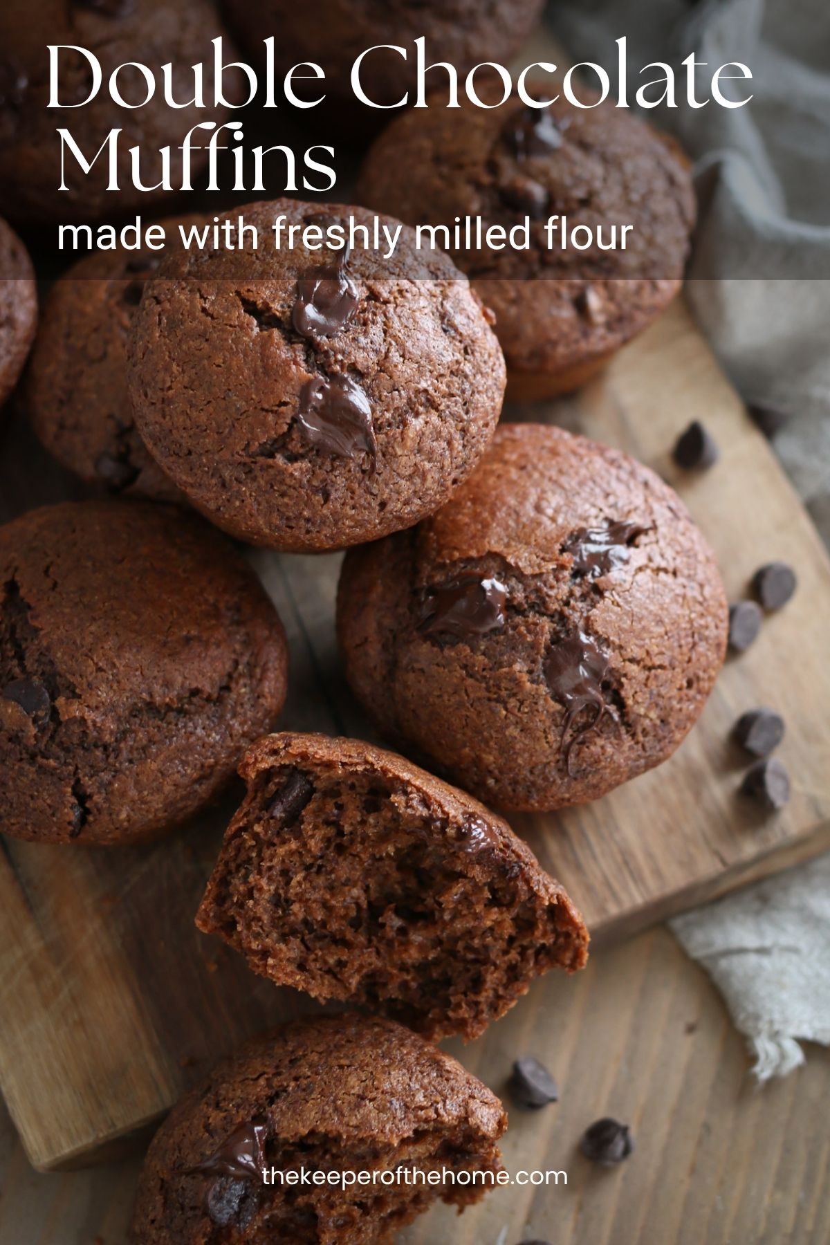 Several double chocolate muffins made with fresh milled flour rest on a cutting board