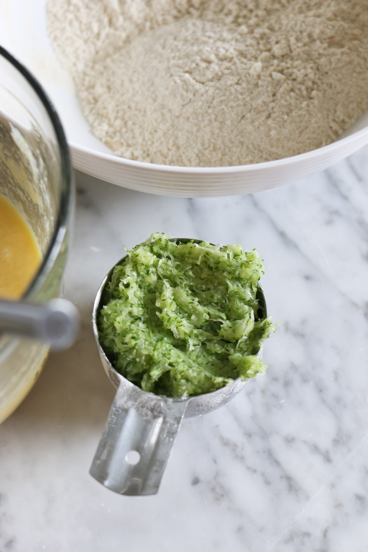 A measuring cup holds pureed zucchini